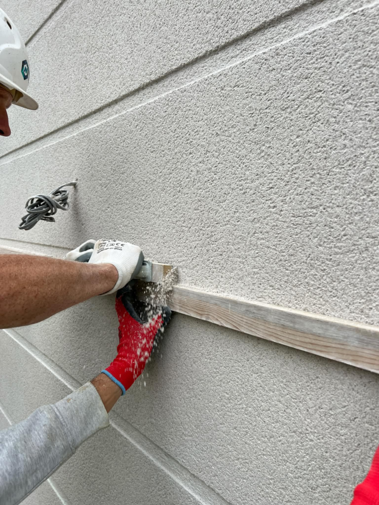Experienced rendering contractor in Surrey preparing external masonry walls before applying a new render system